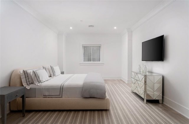 bedroom with ornamental molding, recessed lighting, baseboards, and wood finished floors