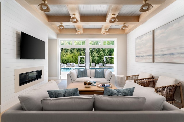 living area featuring a large fireplace and beam ceiling