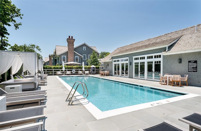 community pool featuring fence and a patio