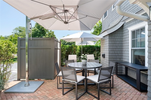 view of patio / terrace with outdoor dining space and fence