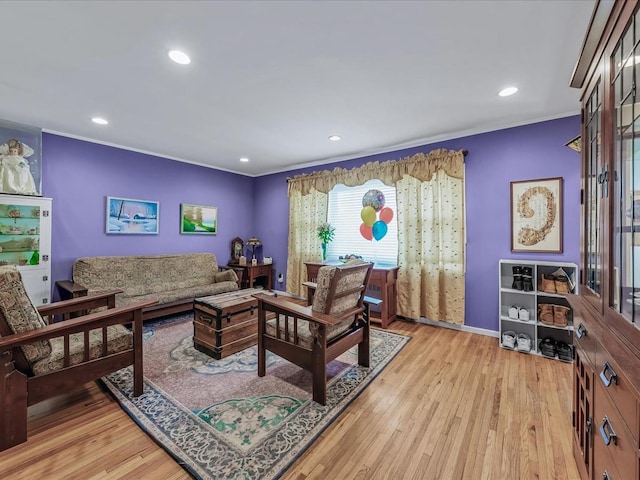 living area with ornamental molding, light wood finished floors, baseboards, and recessed lighting