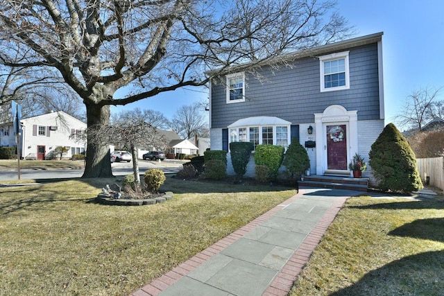 view of front of property with a front yard and brick siding