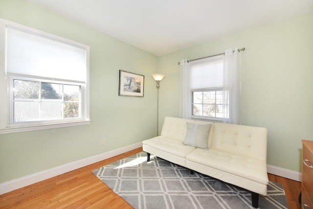 sitting room featuring baseboards and wood finished floors