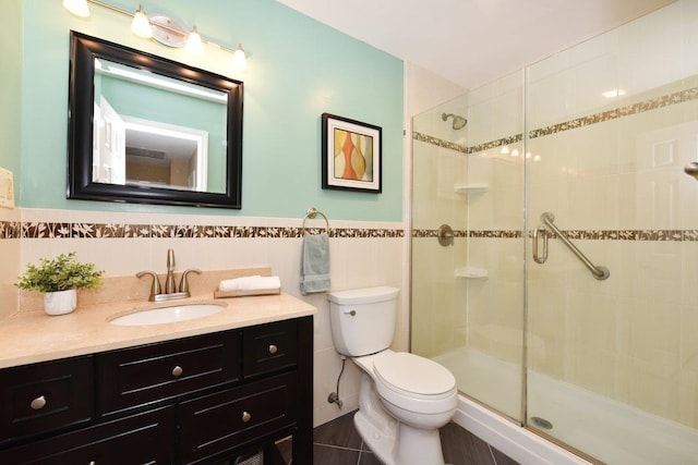 bathroom featuring tile walls, a shower stall, and vanity