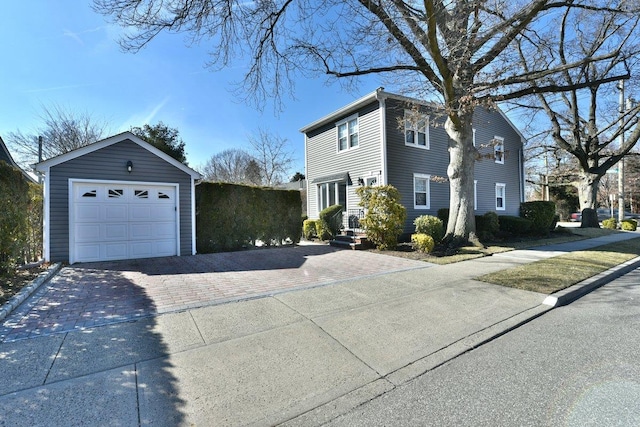 view of side of property with an outbuilding and decorative driveway