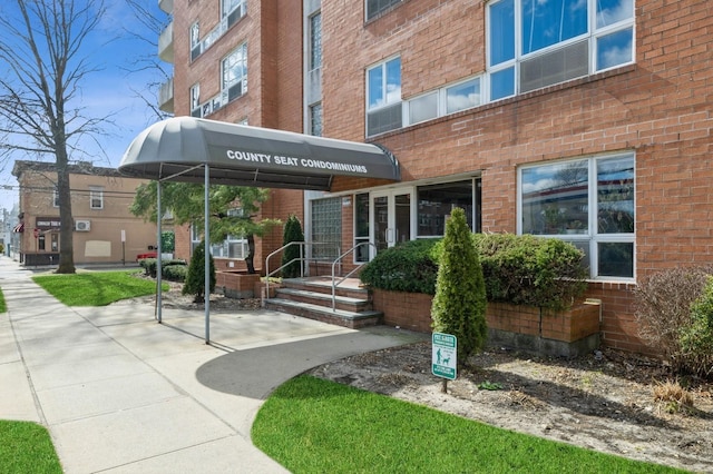 property entrance featuring brick siding