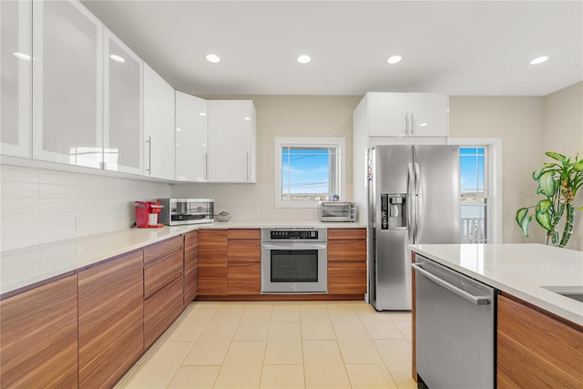 kitchen featuring white cabinetry, modern cabinets, appliances with stainless steel finishes, and light countertops