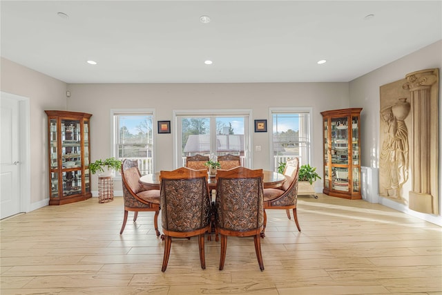 dining area with light wood-style floors, baseboards, and recessed lighting