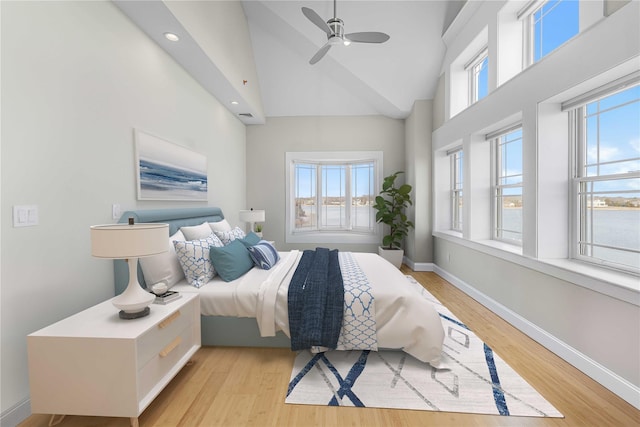 bedroom featuring light wood-type flooring, multiple windows, and baseboards