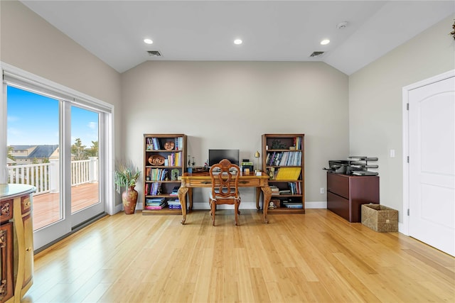 office space with vaulted ceiling, light wood finished floors, and visible vents