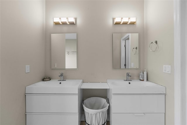 bathroom featuring two vanities and a sink