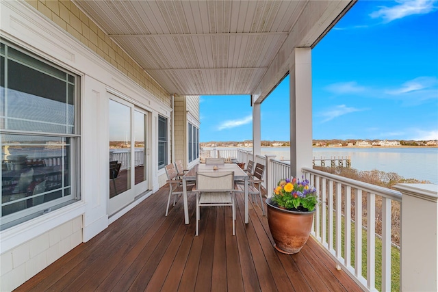 exterior space with outdoor dining space and a water view