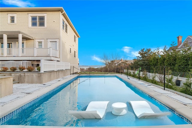 view of swimming pool with fence and a fenced in pool