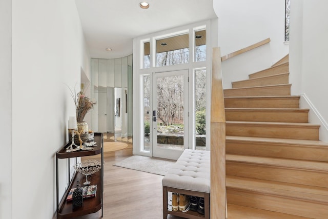 entrance foyer with recessed lighting, wood finished floors, and stairs