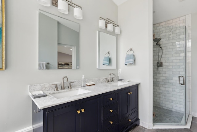 full bathroom featuring a sink, a stall shower, and double vanity