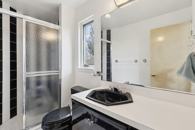 full bath featuring vanity, a shower stall, and toilet