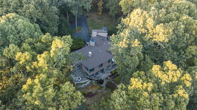 drone / aerial view featuring a wooded view