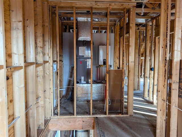 misc room with water heater and heating unit