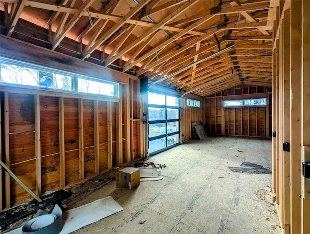 miscellaneous room featuring a garage and lofted ceiling