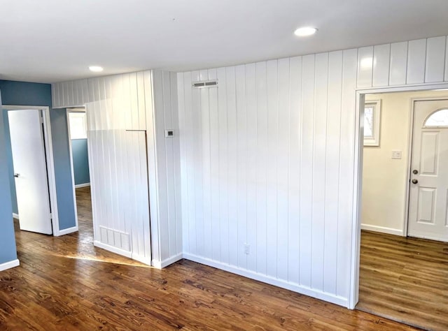 unfurnished room with baseboards, dark wood-type flooring, and recessed lighting