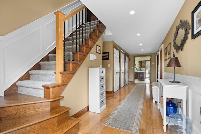 entryway featuring stairs, recessed lighting, french doors, and light wood-style flooring