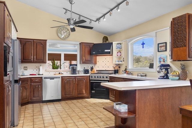 kitchen featuring appliances with stainless steel finishes, open shelves, vaulted ceiling, rail lighting, and a peninsula