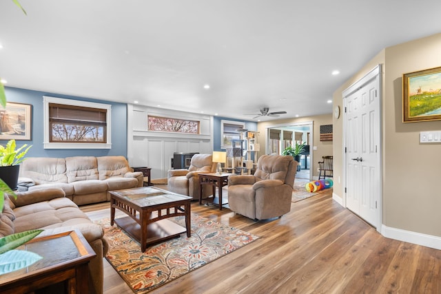living room with recessed lighting, ceiling fan, baseboards, and light wood finished floors