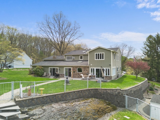 rear view of house featuring a lawn, a patio, and a fenced backyard
