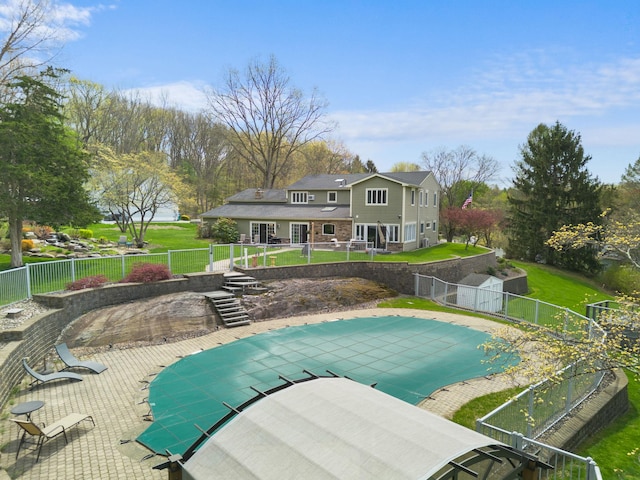 view of pool with a lawn, a fenced in pool, a fenced backyard, and a patio area