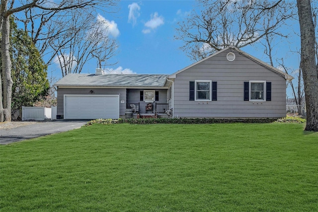 ranch-style home with a garage, a chimney, aphalt driveway, fence, and a front lawn