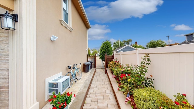 view of home's exterior featuring a gate, a patio area, fence, and stucco siding