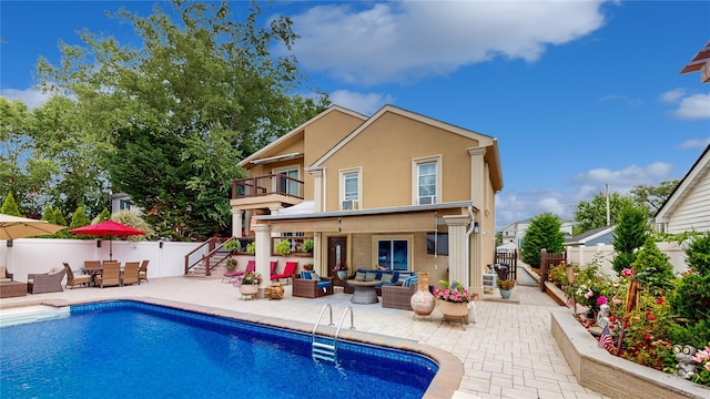 rear view of property with a patio area, a fenced backyard, an outdoor living space, and stucco siding