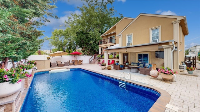 view of swimming pool featuring a fenced backyard, an outdoor hangout area, a fenced in pool, and a patio