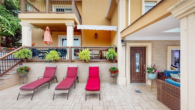 exterior space featuring a patio area and stucco siding