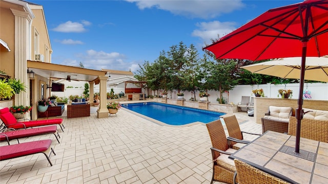 view of pool featuring a fenced in pool, a patio, ceiling fan, a fenced backyard, and outdoor lounge area