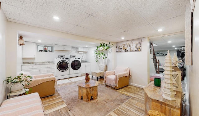 washroom featuring recessed lighting, laundry area, baseboards, light wood-style floors, and independent washer and dryer