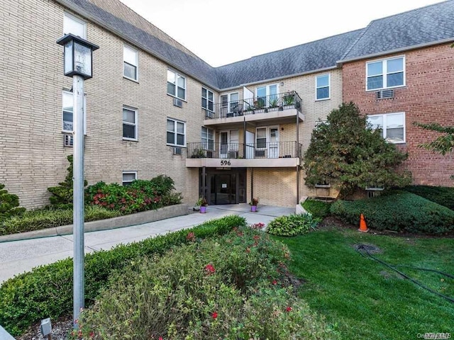 exterior space featuring brick siding and a front lawn