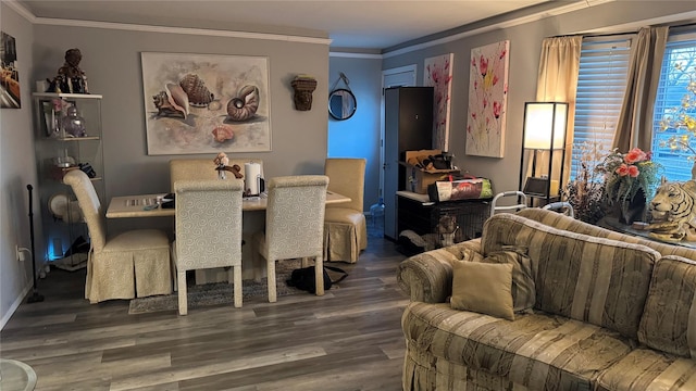 dining area with wood finished floors and crown molding