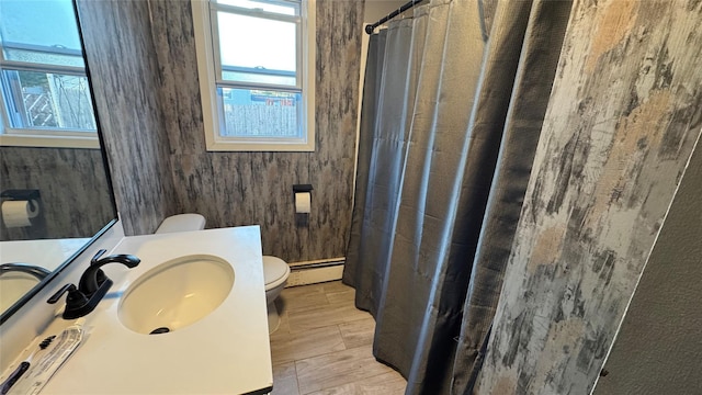 bathroom with baseboard heating, vanity, toilet, and a shower with curtain