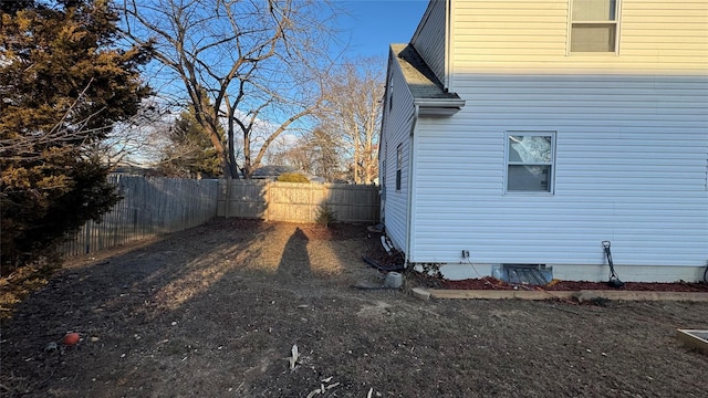 view of property exterior featuring crawl space, roof with shingles, and a fenced backyard