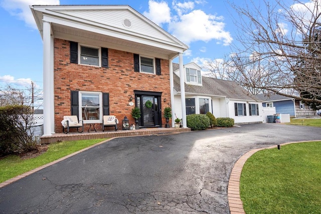 view of front of house featuring aphalt driveway and brick siding