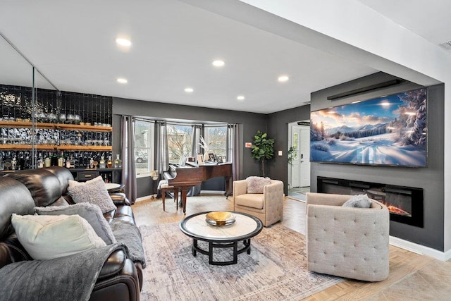 home theater room with bar, recessed lighting, visible vents, baseboards, and a glass covered fireplace