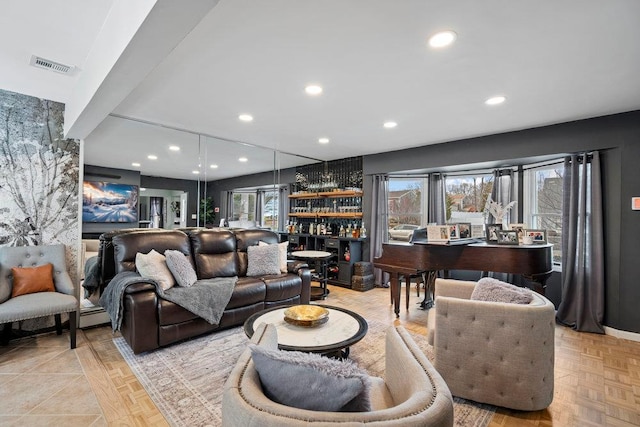 living area with a healthy amount of sunlight, bar area, visible vents, and recessed lighting