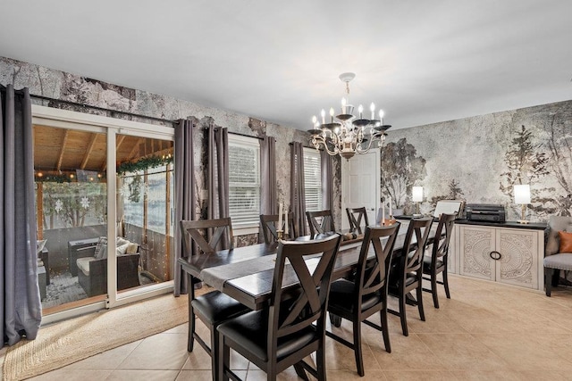 dining space with light tile patterned floors, an inviting chandelier, and wallpapered walls