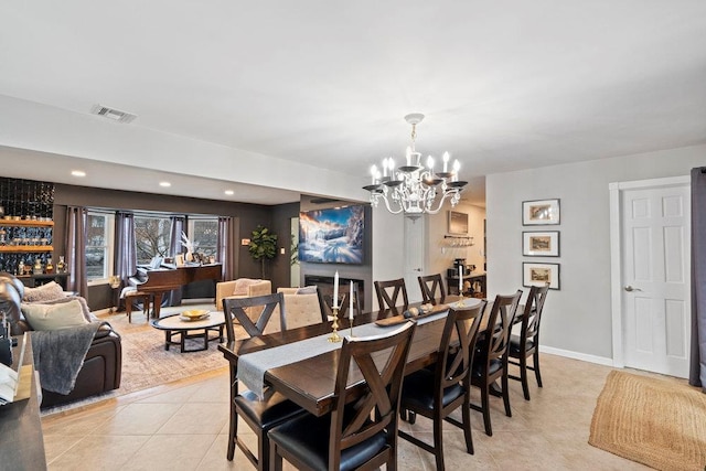 dining space with baseboards, visible vents, an inviting chandelier, light tile patterned flooring, and recessed lighting