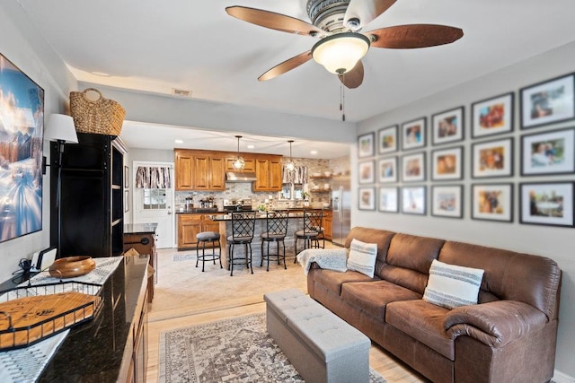 living area with ceiling fan