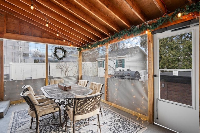 sunroom / solarium featuring lofted ceiling