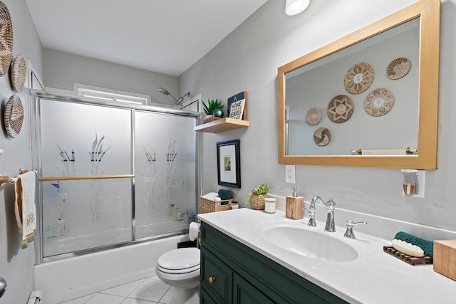 full bathroom featuring vanity, shower / bath combination with glass door, tile patterned flooring, and toilet