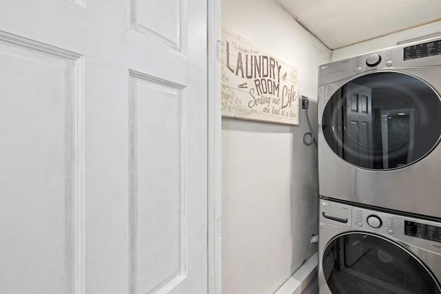 washroom featuring stacked washer and clothes dryer