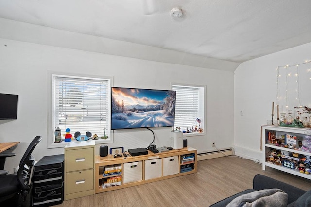 living room featuring a baseboard heating unit, a wealth of natural light, vaulted ceiling, and light wood-style flooring